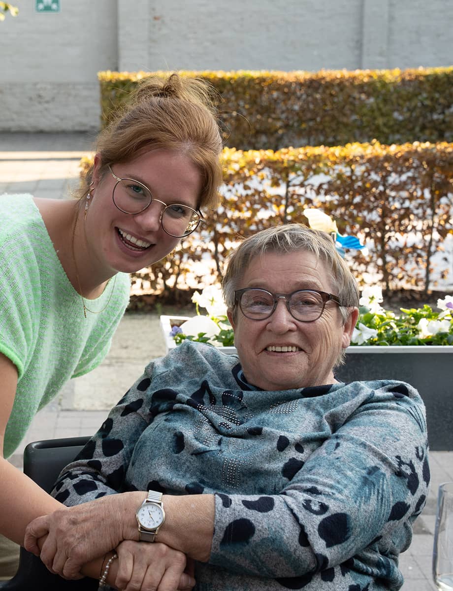 A woman in a suit sits at a desk, working on a laptop